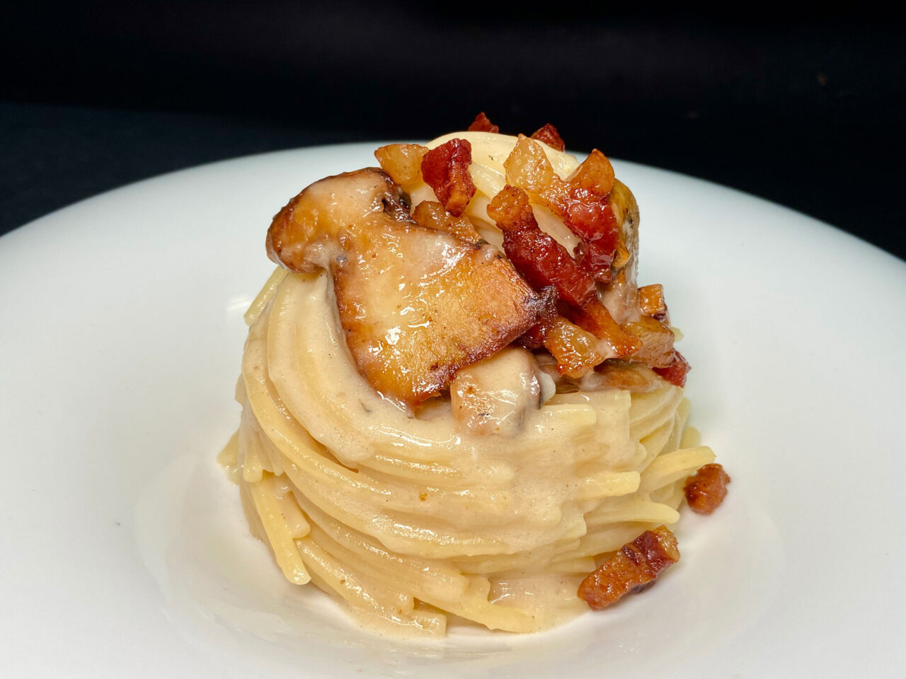 Spaghettone mit Steinpilzen, Speck und Creme aus Parmesankäse