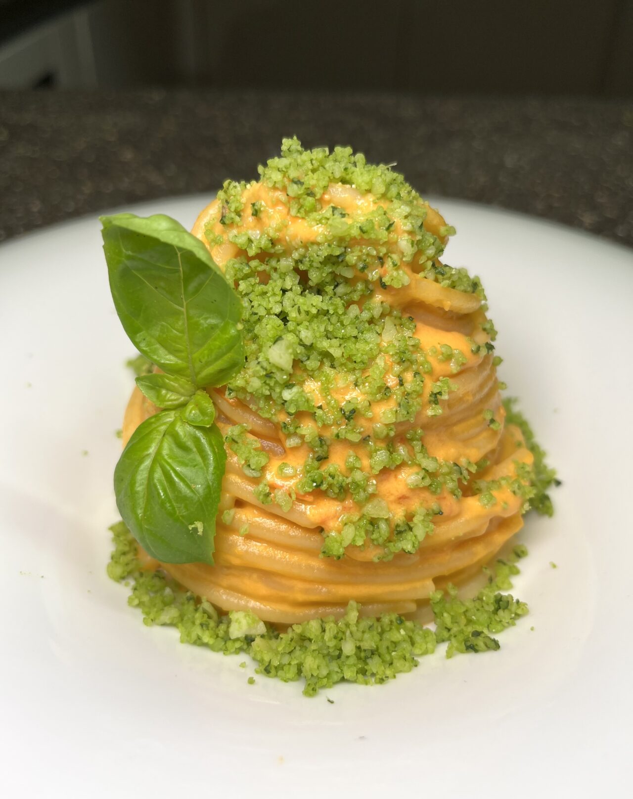 Spaghettone con crema di datterini gialli e burrata e Parmigiano aromatizzato al basilico